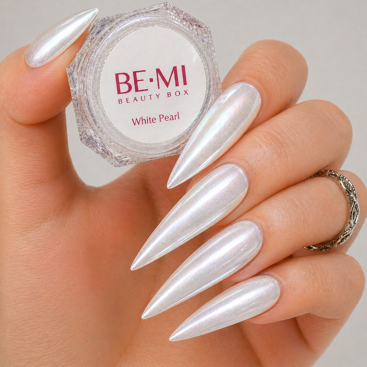 Finished manicured nails with a high-shine liquid metal effect using BEMI Chrome in White Pearl, burnished flawlessly over a gel base for professional nail artistry.