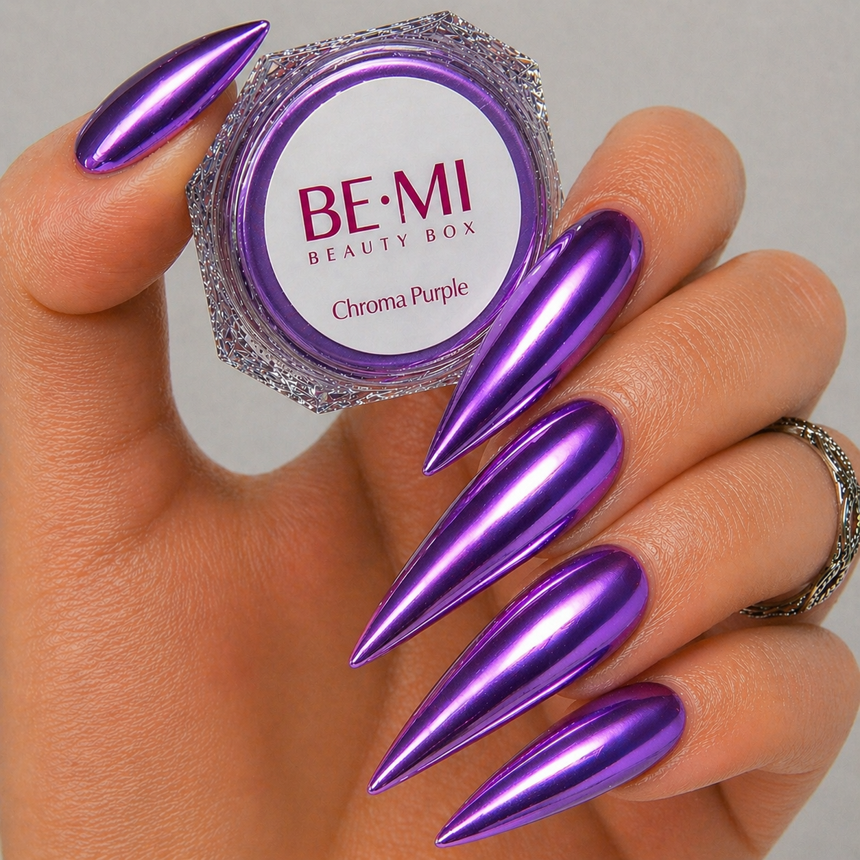Finished manicured nails with a high-shine liquid metal effect using BEMI Chrome in Chroma Purple, burnished flawlessly over a gel base for professional nail artistry.