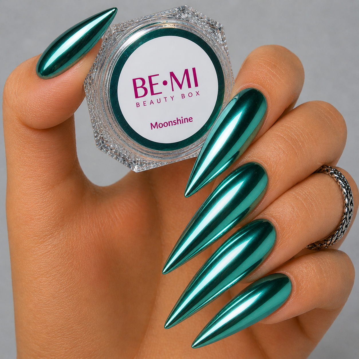 Finished manicured nails with a high-shine liquid metal effect using BEMI Chrome in Moonshine, burnished flawlessly over a gel base for professional nail artistry.