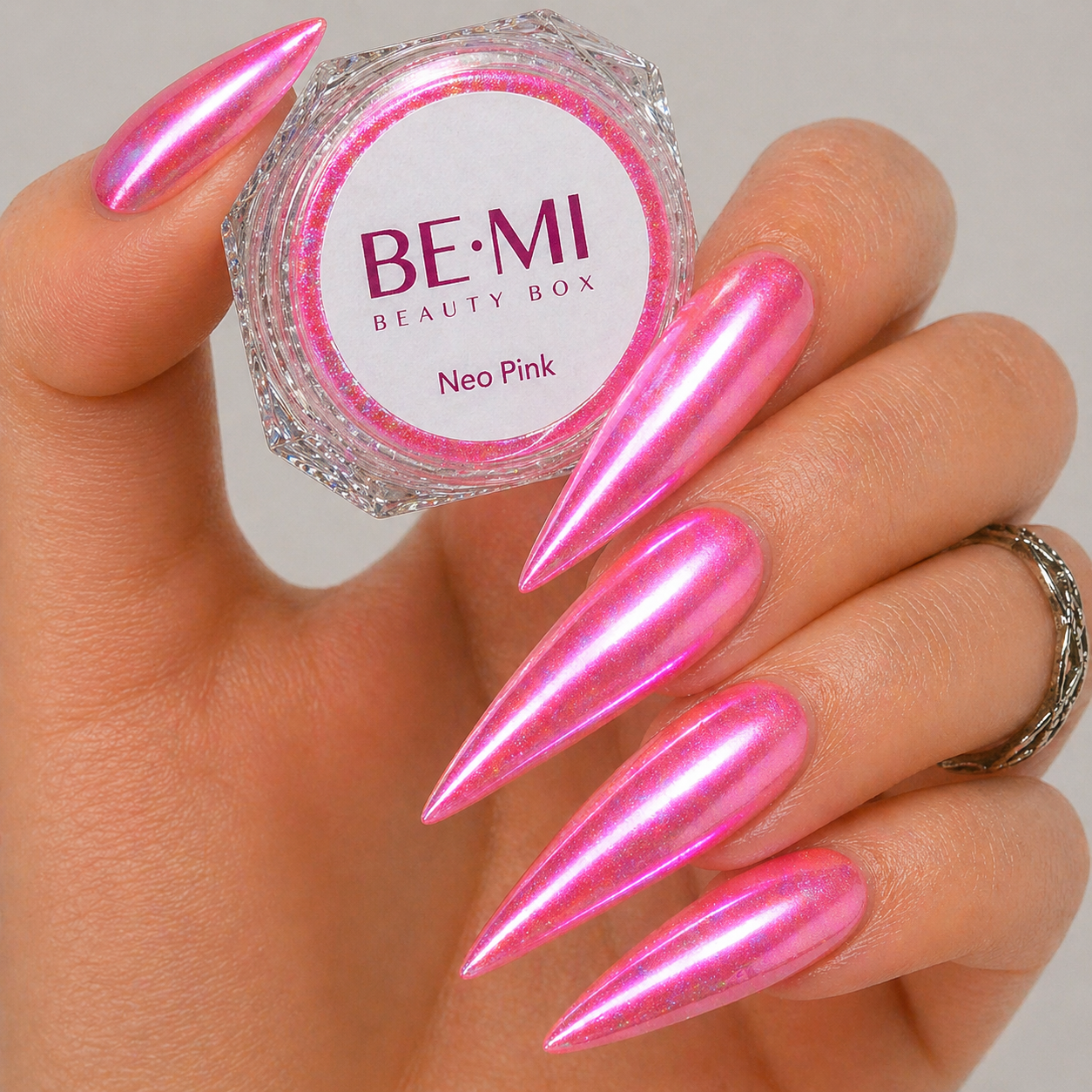 Finished manicured nails with a high-shine liquid metal effect using BEMI Chrome in Neo Pink, burnished flawlessly over a gel base for professional nail artistry.