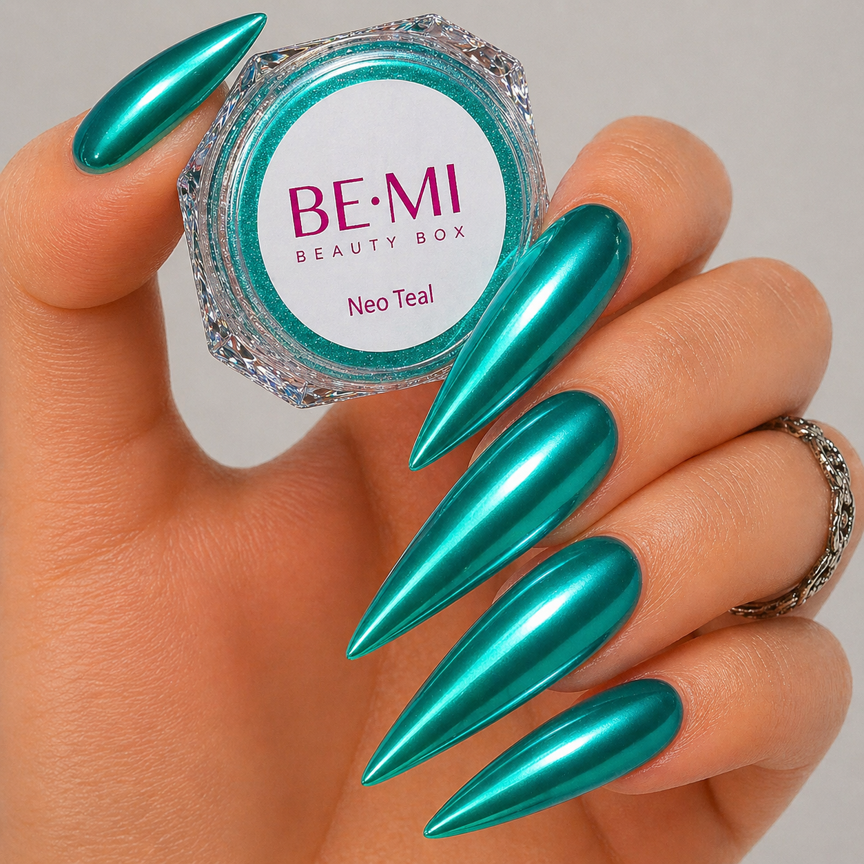 Finished manicured nails with a high-shine liquid metal effect using BEMI Chrome in Neo Teal, burnished flawlessly over a gel base for professional nail artistry.