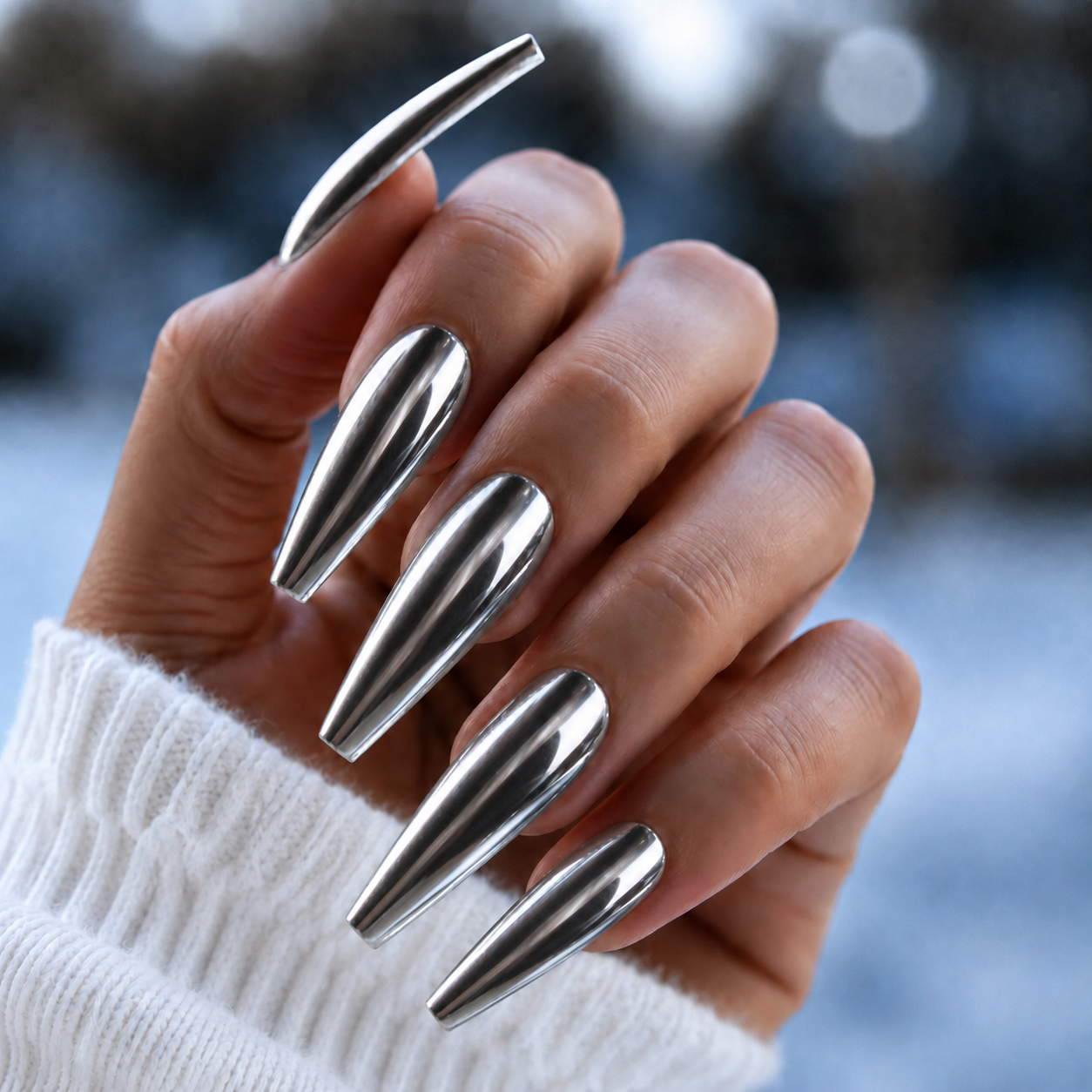 Finished manicured nails with a high-shine liquid metal effect using BEMI Chrome in Silver Mirror, burnished flawlessly over a gel base for professional nail artistry.