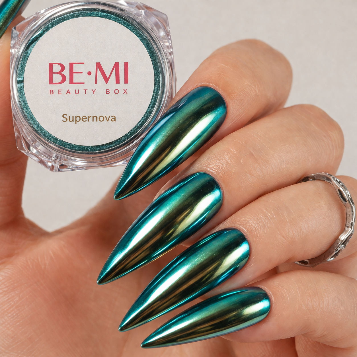 Finished manicured nails with a high-shine liquid metal effect using BEMI Chrome in Supernova, burnished flawlessly over a gel base for professional nail artistry.