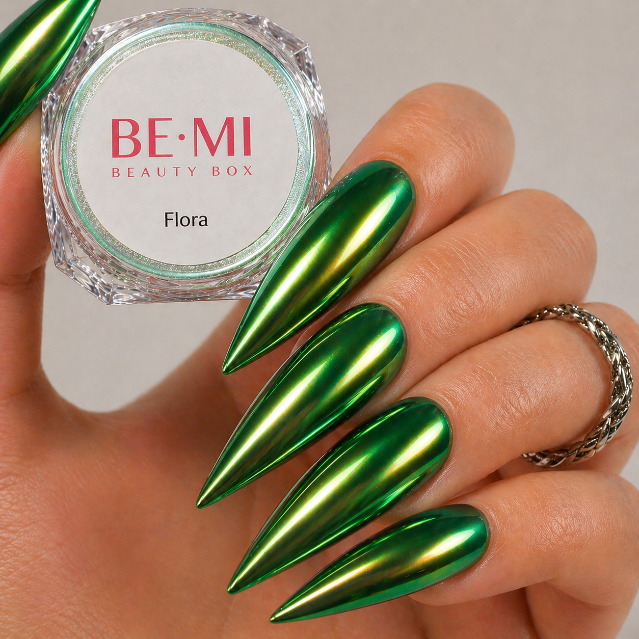 Finished manicured nails with a high-shine liquid metal effect using BEMI Chrome in Flora, burnished flawlessly over a gel base for professional nail artistry.