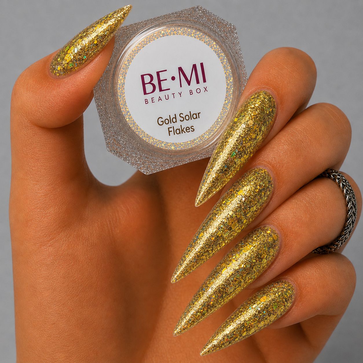 Finished manicured nails with a high-shine liquid metal effect using BEMI Chrome in Solar Flake, burnished flawlessly over a gel base for professional nail artistry.