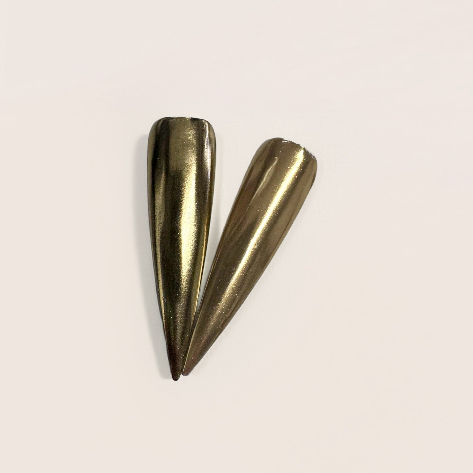 Finished manicured nails with a high-shine liquid metal effect using BEMI Chrome in Light Gold Mirror, burnished flawlessly over a gel base for professional nail artistry.