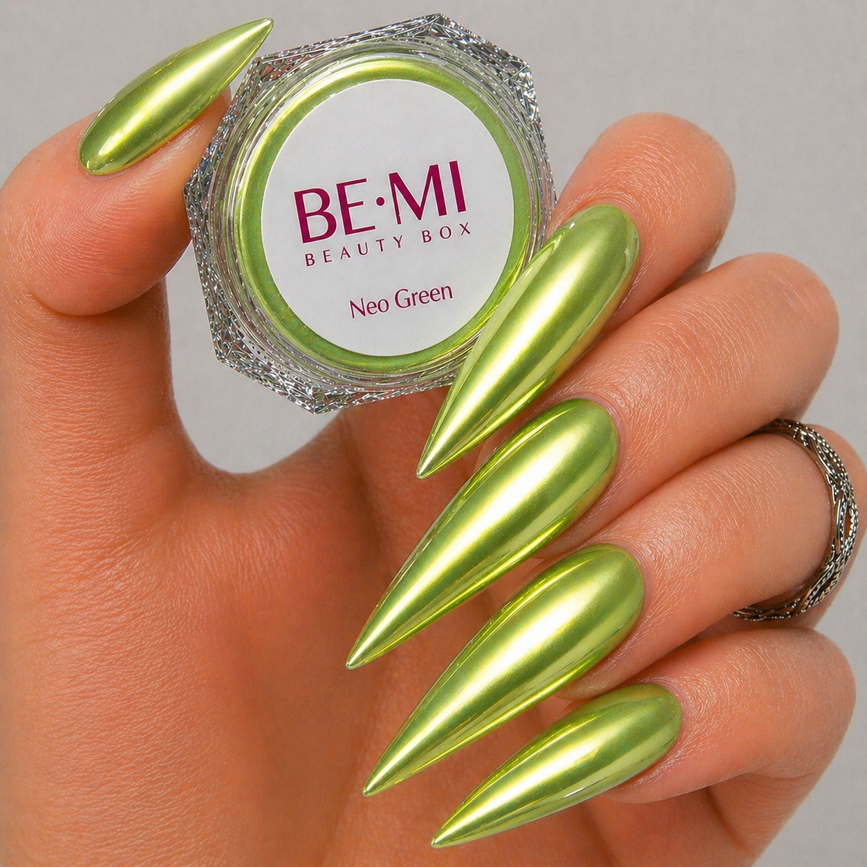 Finished manicured nails with a high-shine liquid metal effect using BEMI Chrome in Neo Green, burnished flawlessly over a gel base for professional nail artistry.