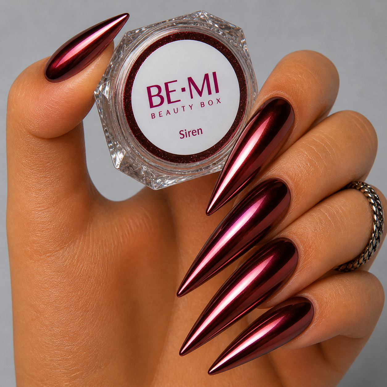 Finished manicured nails with a high-shine liquid metal effect using BEMI Chrome in Siren, burnished flawlessly over a gel base for professional nail artistry.