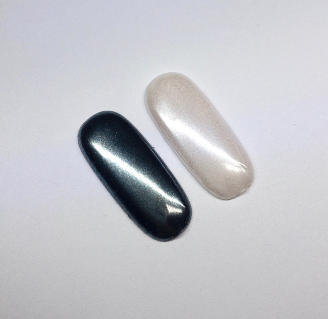 Finished manicured nails with a high-shine liquid metal effect using BEMI Chrome in White Pearl, burnished flawlessly over a gel base for professional nail artistry.